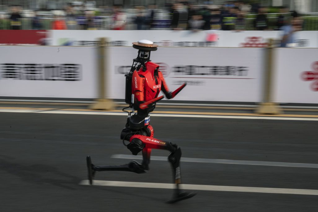 A red and black humanoid robot running
