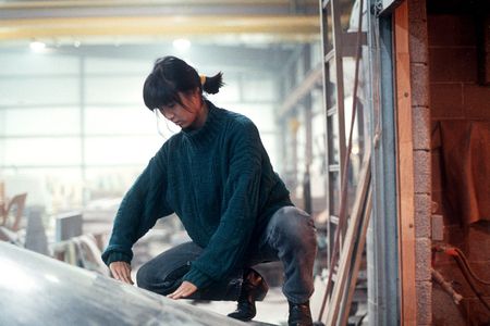 The 1989 photograph, Maya Lin working on Civil Rights Memorial by Adam Stoltman, is among numerous works including 3D models, sketchbooks, personal papers and family photos in the exhibition, "One Life: Maya Lin," at the Smithsonian's National Portrait Gallery.&nbsp;