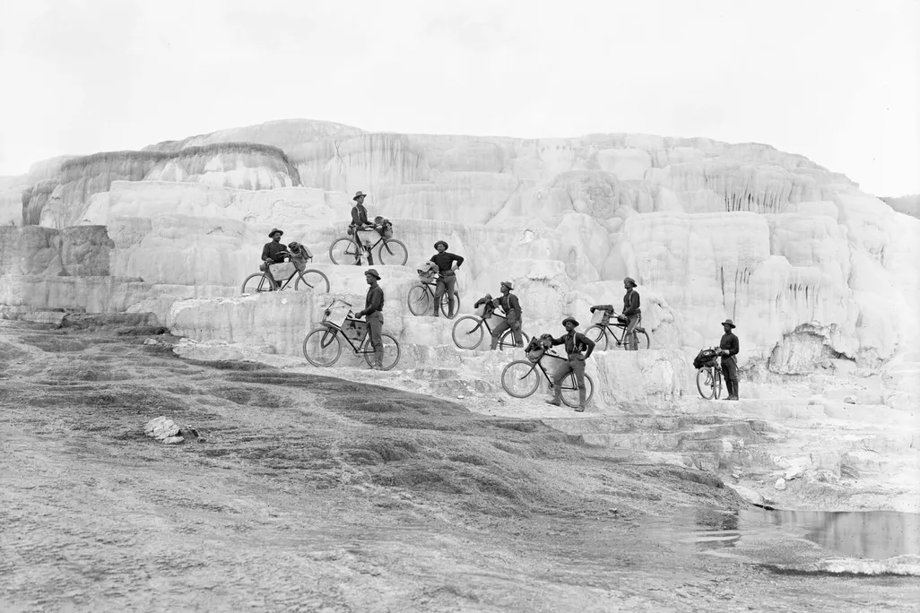 Members of the 25th Infantry Bicycle Corps pose on Minerva Terrace at Mammoth Hot Springs in Yellowstone National Park in 1896