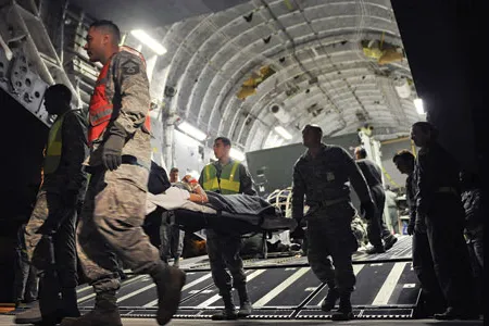 Wounded service members are taken off a C-17 and brought into Scott, which serves as a hub in moving the injured from the battlefield to U.S. treatment facilities.