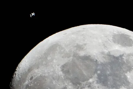 The International Space Station can be seen as a small object in upper left of this image of the moon in the early evening Jan. 4 in the skies over the Houston area flying at an altitude of 242.8 miles. 