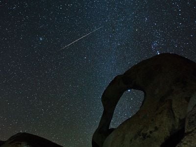 A Geminid meteor streaks through the sky.