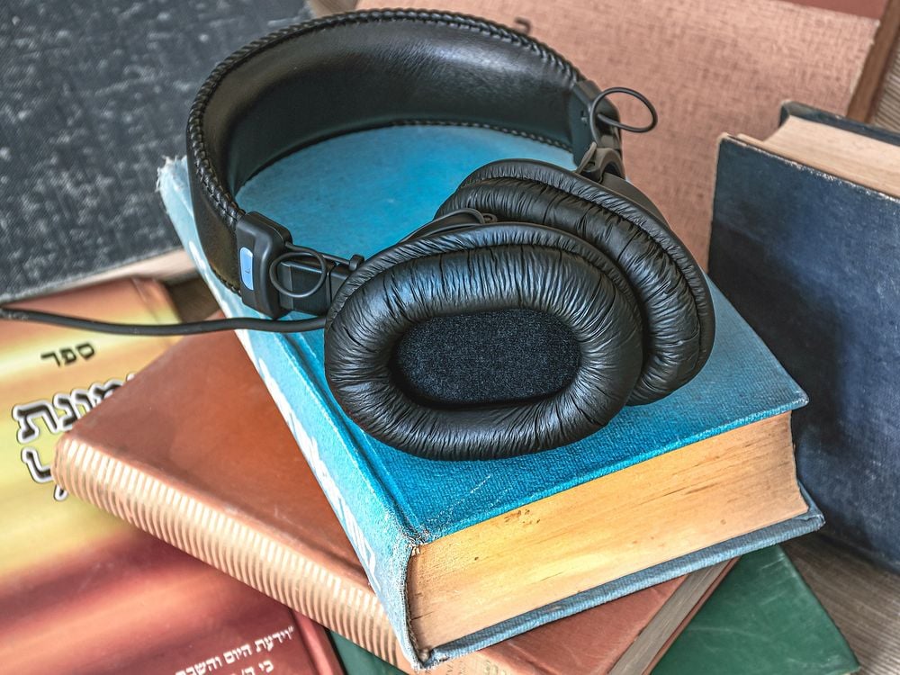 Set of headphones on a stack of books