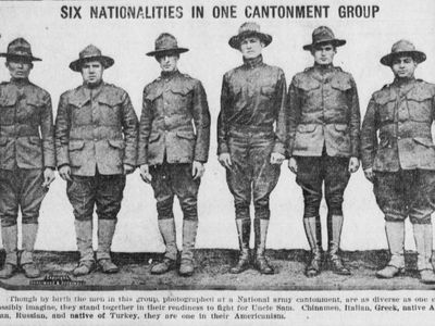 A newspaper's photograph of six men, all of different ethnicities. The caption reads: "Through by birth the men in this group, photographed at a National army cantonment, are as diverse as one could possibly imagine, they stand together in their readiness to fight for Uncle Sam."