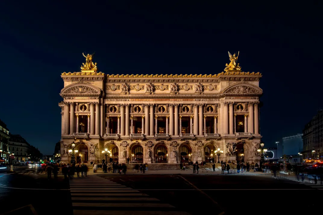 Elaborate opera house against a dark background