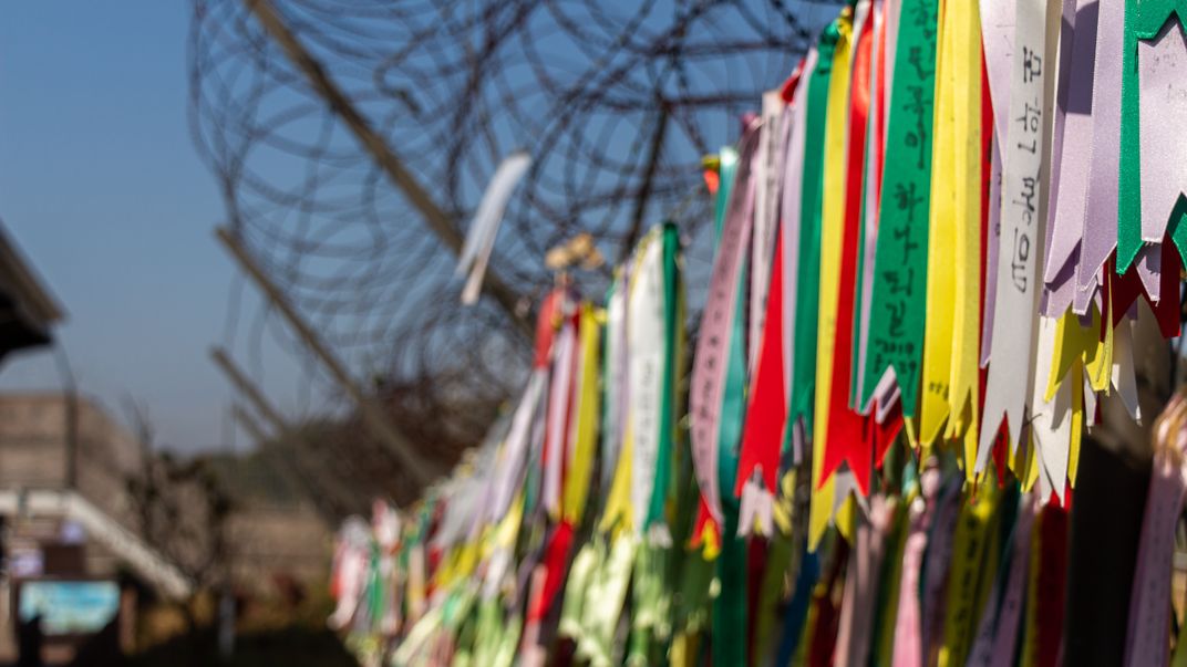 Prayer ribbons festoon a fence in the DMZ