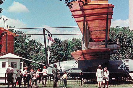 The U.S. Navy’s Curtiss NC-4 became the first aircraft to fly across the Atlantic Ocean, in May 1919. In 1926, Paul Garber persuaded the Navy to preserve the aircraft. The Aircraft Building was too small to house the massive flying boat, so the wings went to Alexandria, Virginia, for storage; the engines and propellers went to Norfolk, while the fuselage remained at the Smithsonian. In 1969, on the 50th anniversary of the flight, the aircraft was restored and placed on temporary display on the National Mall. Today, the NC-4 is on indefinite loan to the National Naval Aviation Museum in Pensacola, Florida.