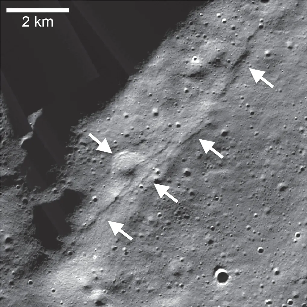 arrows point to some lines and surface texture on an image of the cratered moon