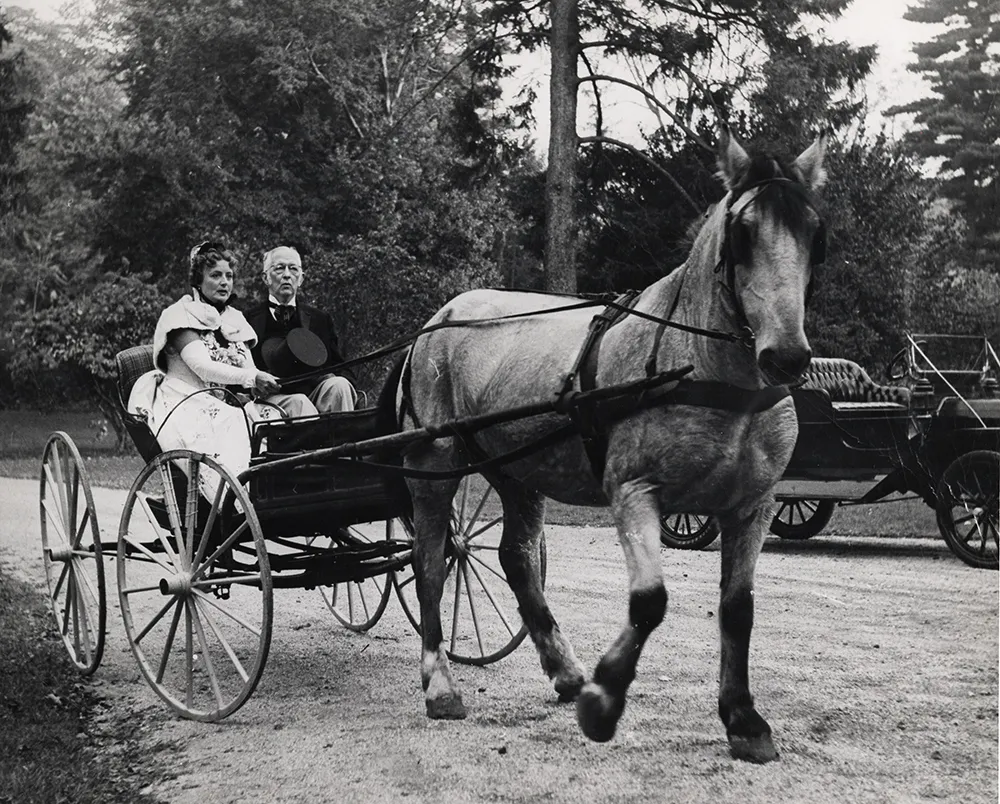 Photograph of Charles Sheeler and his wife Musya arrving at a party in a carriage.