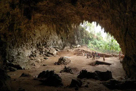 Liang Bua cave on Flores Island, where Homo floresiensis remains were discovered in 2003. Nearby is a village where the pygmies live. 