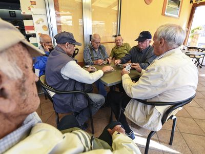 A group of old men playing cards in a bar in Acciaroli, southern Italy, in 2016. The town&nbsp;has a disproportionately high number of centenarians.