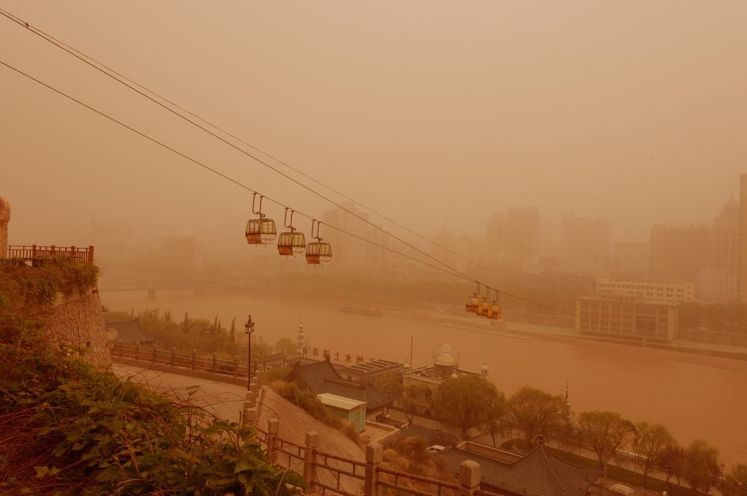 View of cable cars in a sandstorm in Lanzhou city, northwest Chinas Gansu province, 24 April 2014 Credit: Imaginechina/Corbis