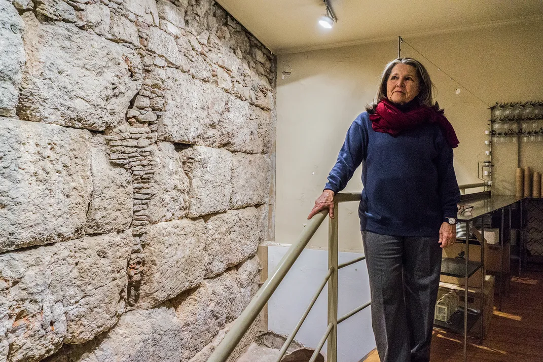 Lydia Carras next to a wall in ELLET's basement