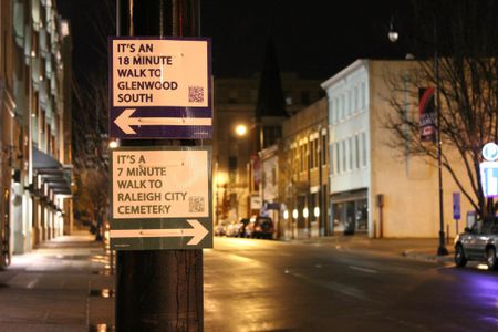 Signs with arrows pointing the way to popular destinations, along with average walking times, popped up in Raleigh.