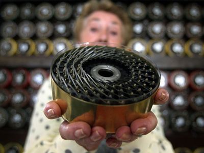 Jean Valentine, a former Bombe machine operator, shows a drum of the machine in Bletchley Park Museum in Bletchley, England.