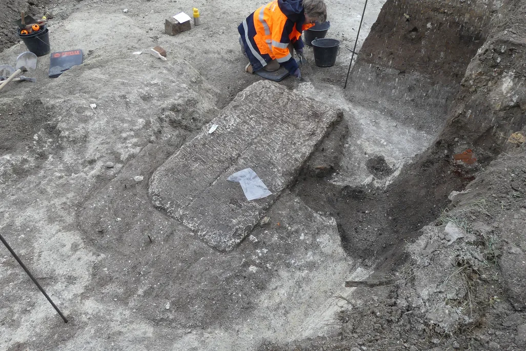 Limestone sarcophagus being excavated