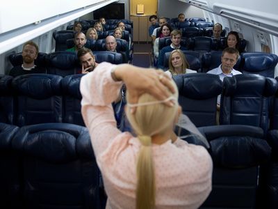 British Airways instructor Diane Pashley demonstrates how to put on an oxygen mask during a flight-safety course at BA’s training facility near Heathrow Airport. Passengers on real flights are often less attentive to safety briefings.