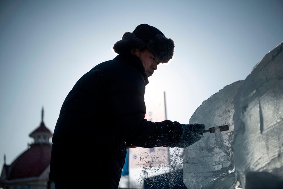 man carving ice