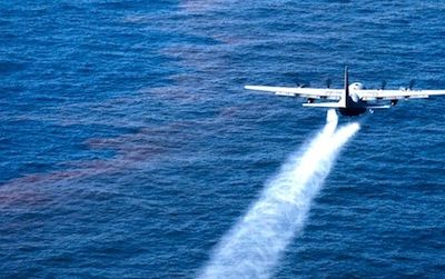 An Air Force plane sprays dispersant onto the Gulf of Mexico following the Deepwater Horizon spill. New research could produce safer dispersants that include ingredients found in food.