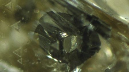 A hexagonal grain of iron sulfide in a diamond may be a flaw for jewelers, but it's useful data for scientists