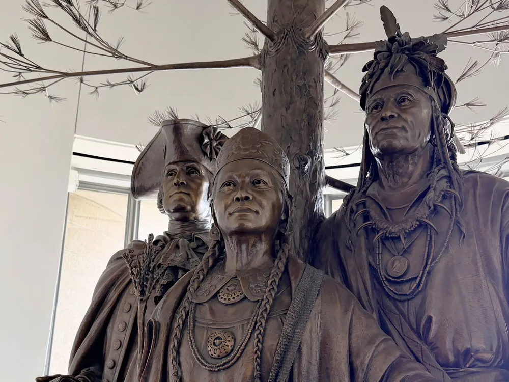 Detailed photo of a bronze sculpture depicting George Washington, Polly Cooper, and Skenandoah from the waist up.