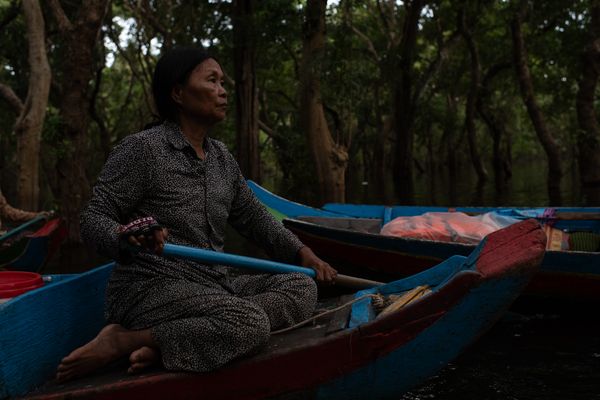 A woman rowing a canoe in the mangroove forest thumbnail