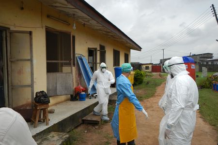 World Health Organization workers gear up to go into an old Ebola isolation ward in Lagos, Nigeria. 