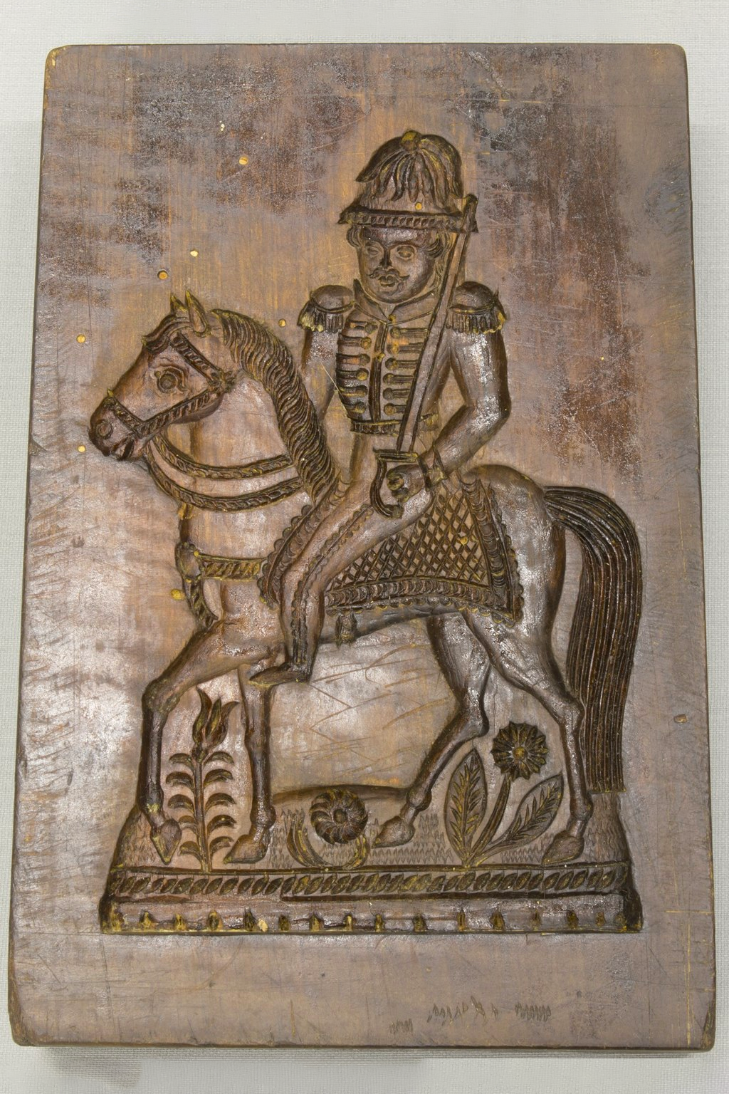 A springerle mold depicting a man on a horse