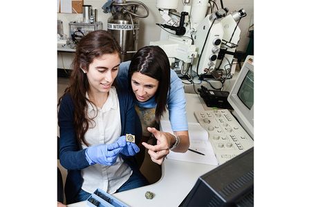 Smithsonian geologist Elizabeth Cottrell (right) helps undergraduate intern Kellie Wall examine a sample of Earth’s interior. Cottrell co-directs Natural History Research Experiences, a program funded by the National Science Foundation that trains 18 students every summer.