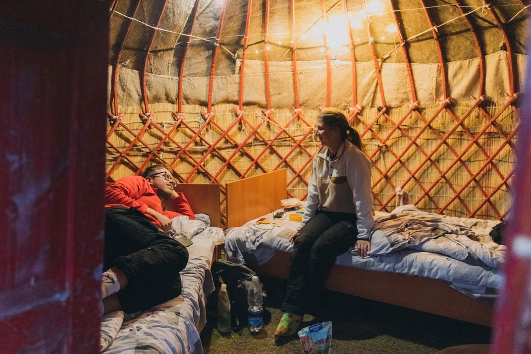 Backpackers relax in a yurt in the Tian Shan mountains