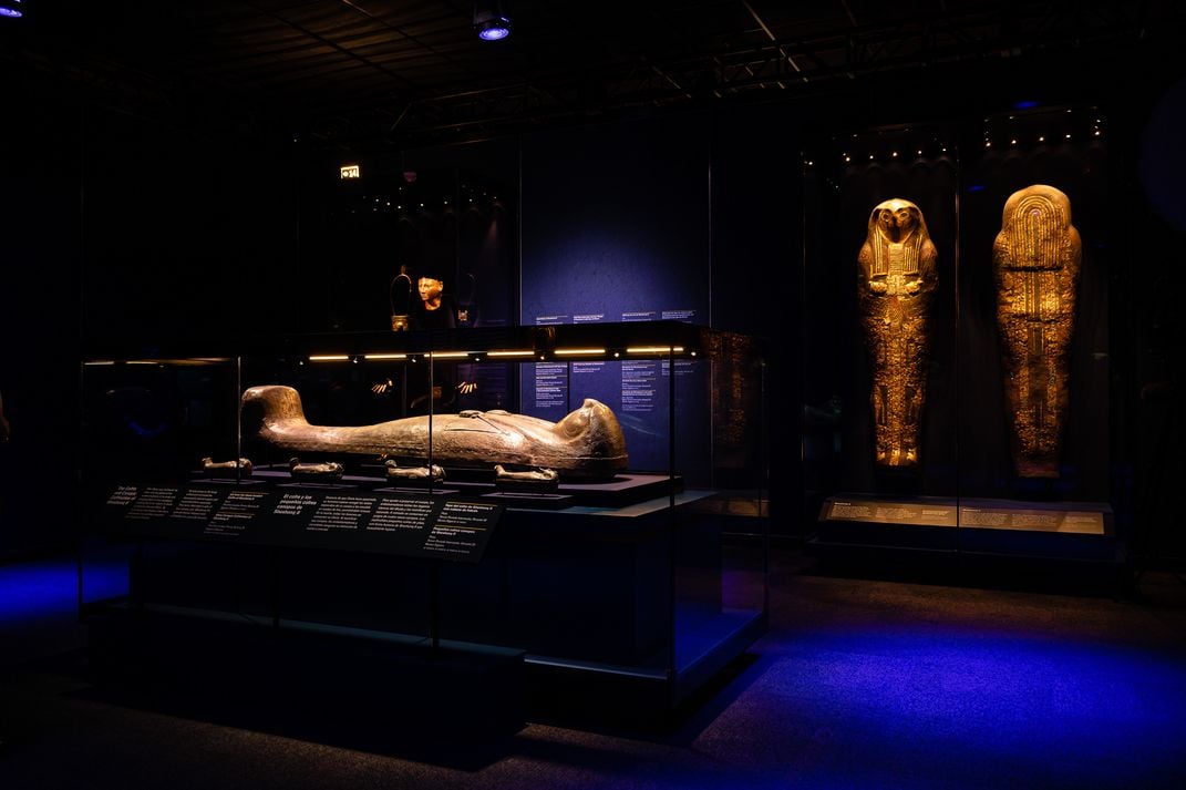 View of exhibition, featuring sarcophagus in the center of the room
