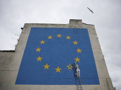 The Banksy mural in Dover, England, showed a worker chipping away a star on the European Union flag.
