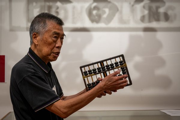 A man holding an abacus thumbnail