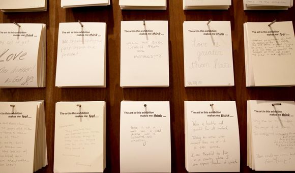 Visitors leave hand-written notes after viewing the exhibition, 