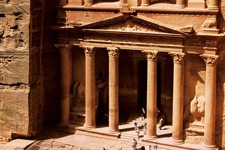 One of the few entryways into Petra is a narrow passage, the Siq, at the end of which Petrans carved elaborate monuments into the soft rock.