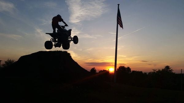 Quad jumping into the sunset thumbnail