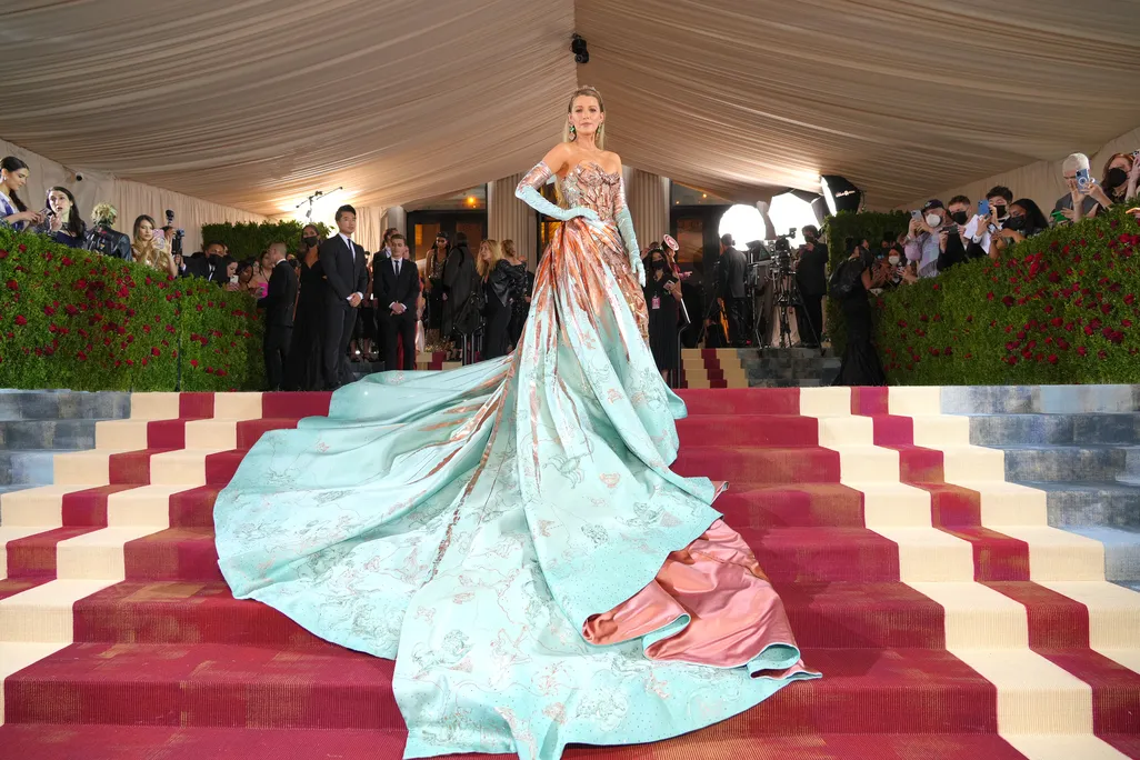 Actress Blake Lively wore a gown whose copper bow unfurled into a blue-green train.