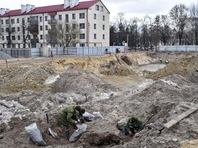 Belarus' servicemen excavate a mass grave for the prisoners of a Jewish ghetto set up by the Nazis during World War II in the city of Brest.
