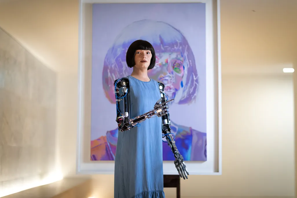 Ai-Da in front of self-portrait