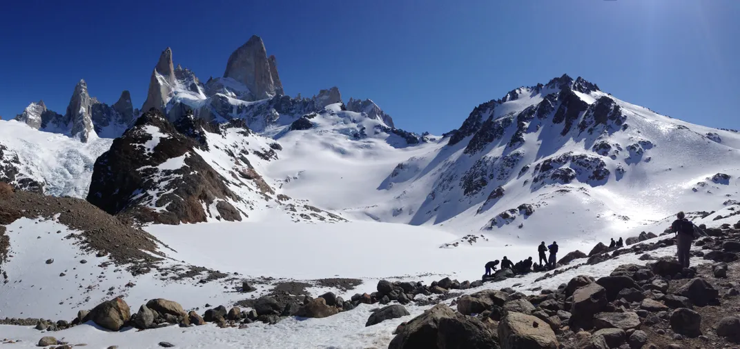 Hikers climb up a snow covered mountain