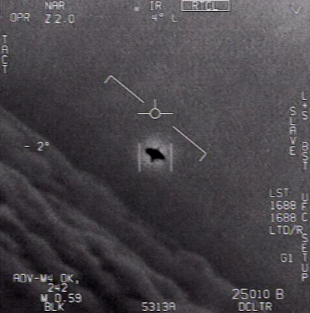 A black, unidentified object in the sky captured by a U.S. Navy jet.