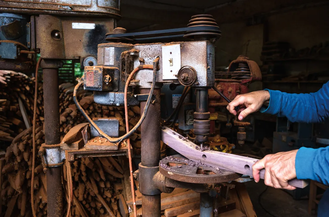 a detail of a drill going into wood