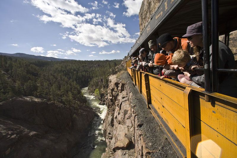 The narrow-gauge Durango & Silverton train steams through history above the Animas River.