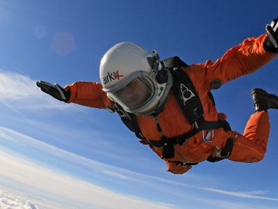 Steve Truglia practices for his 120,000-foot jump with a shorter fall over the countryside north of London, wearing a flight suit and helmet worn by Russian fighter pilots for high altitude missions.