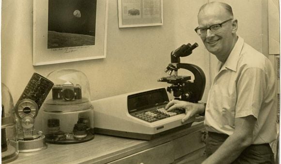 Arthur C. Clarke poses for a photo while he sits at his desk, circa 1969.