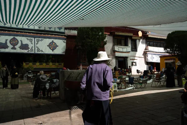An aged devotee navigating the temple thumbnail