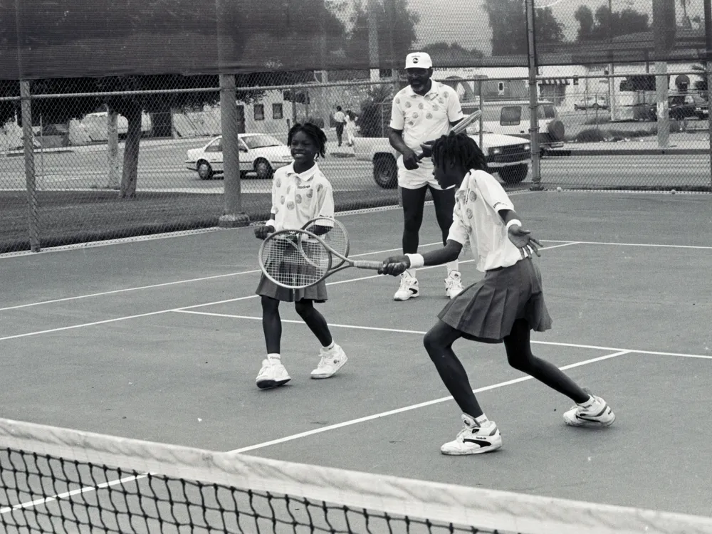 Serena, Venus and their father on the tennis court