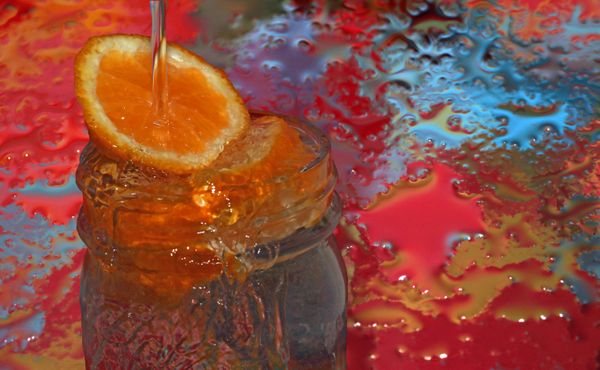 Water Splash Over Orange Slice and Mason Jar thumbnail