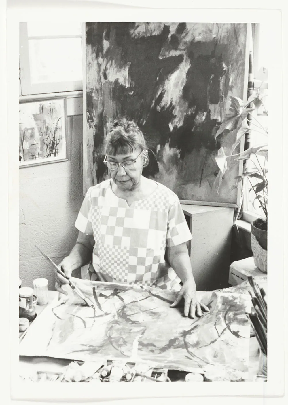 Photograph of Alma Thomas painting in her studio