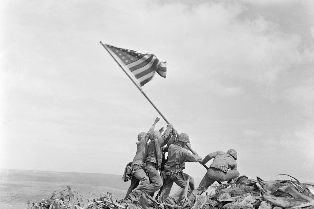 Soldiers raising American flag